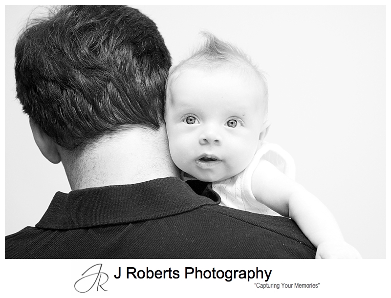Baby girl looking over her daddy's shoulder - sydney baby photographer 